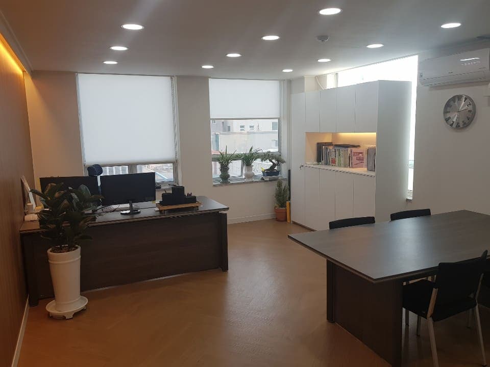다크우드 데스크와 회의 테이블이 있는 상담실